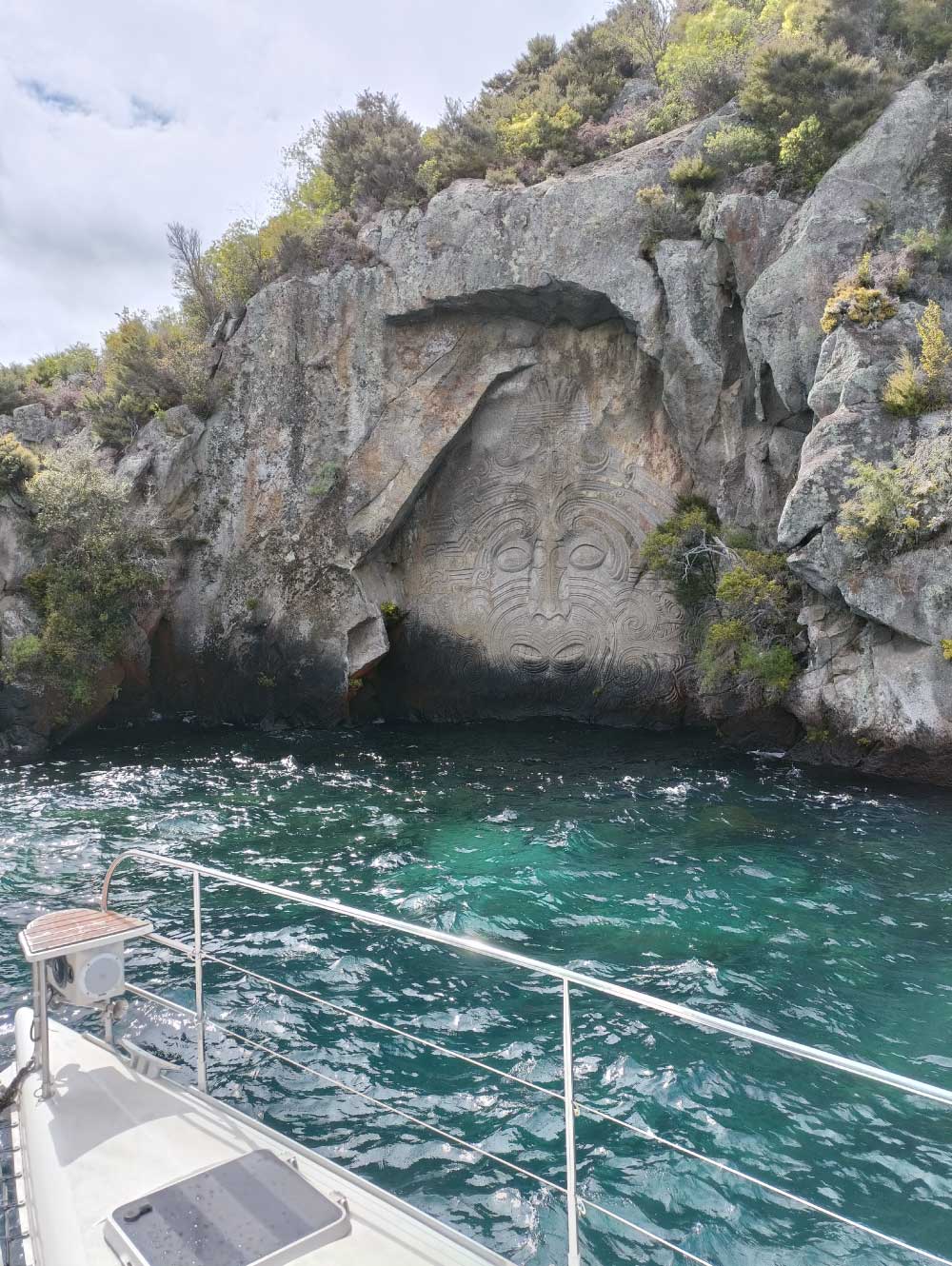 Ngātoroirangi Mine Bay Māori Rock Carvings on Lake Taupō cliffs, a famous example of modern Māori artistry in New Zealand.